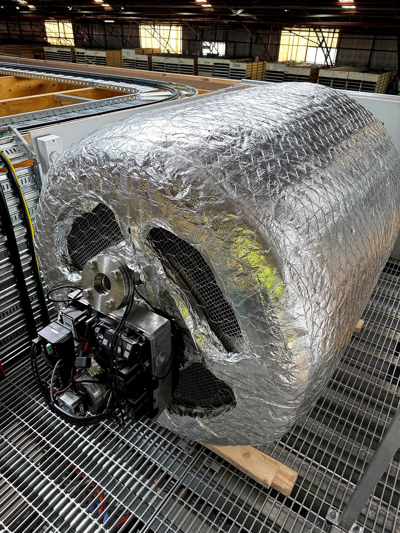 Pipe and vessel insulation on a large industrial motor assembly